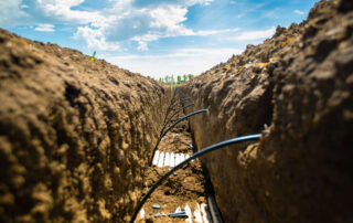 Subsurface drip irrigation dripline trench connections